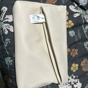 A beautiful cream clutch bag